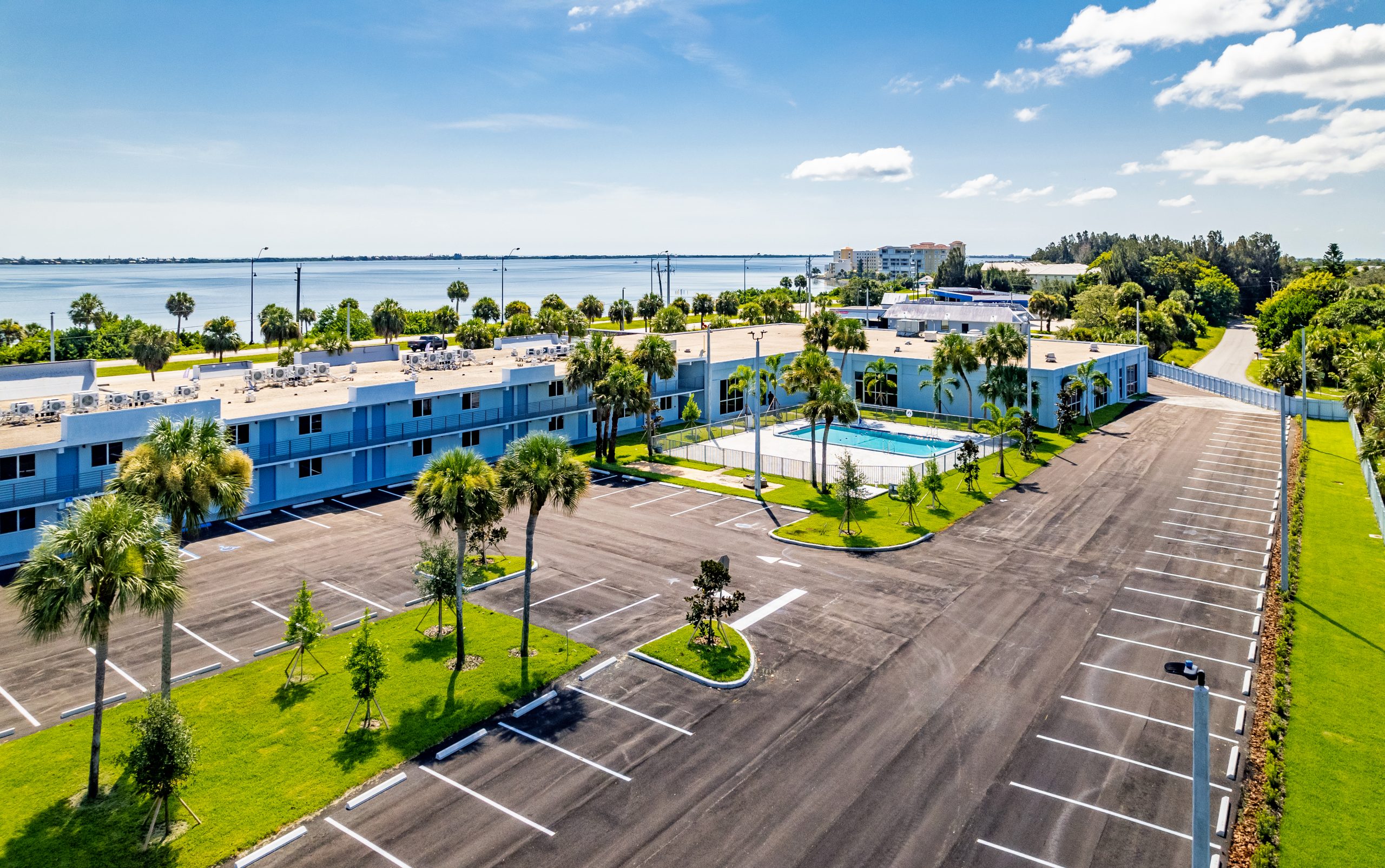 Arial view of parking lot and exterior building with river in the background