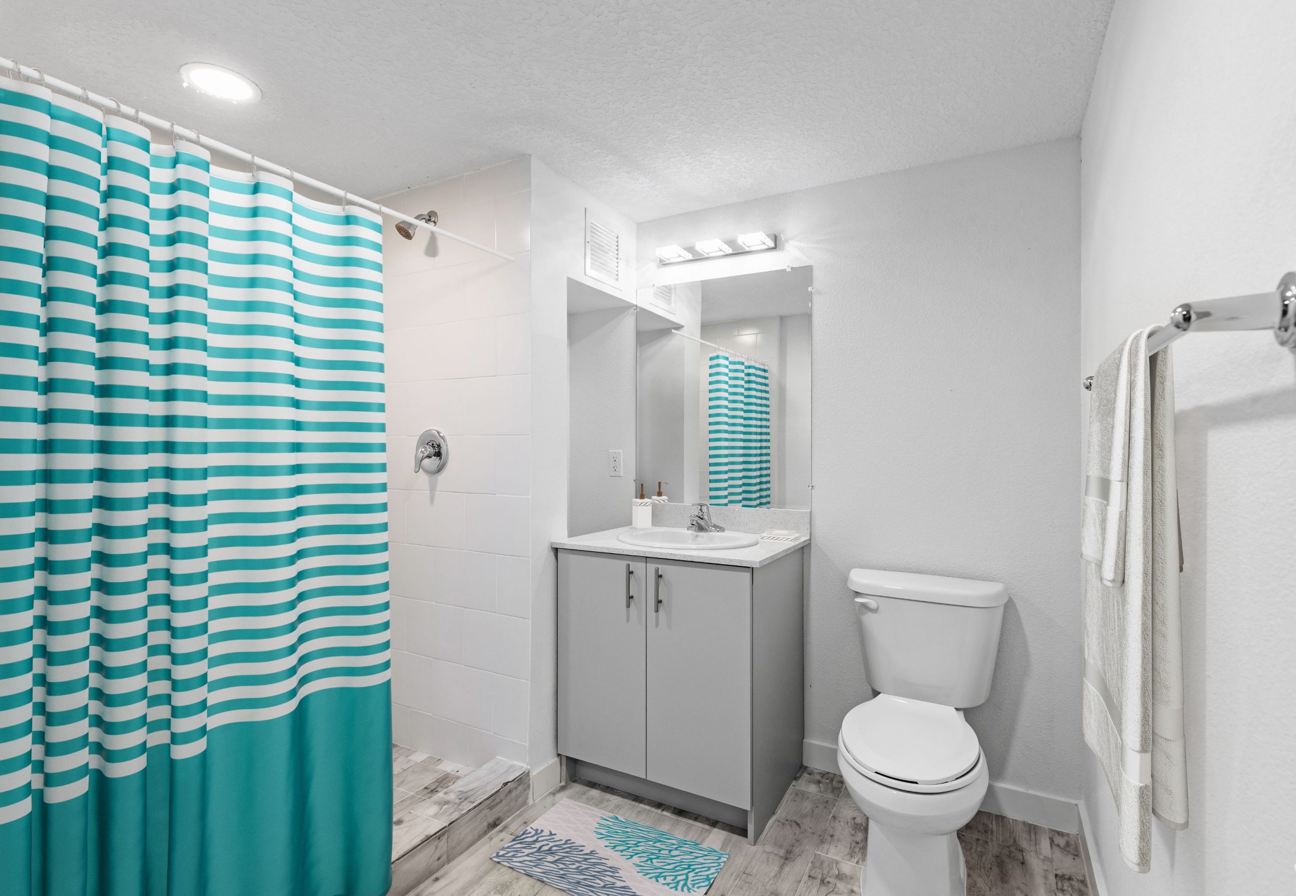 bathroom with single counter sink and toilet